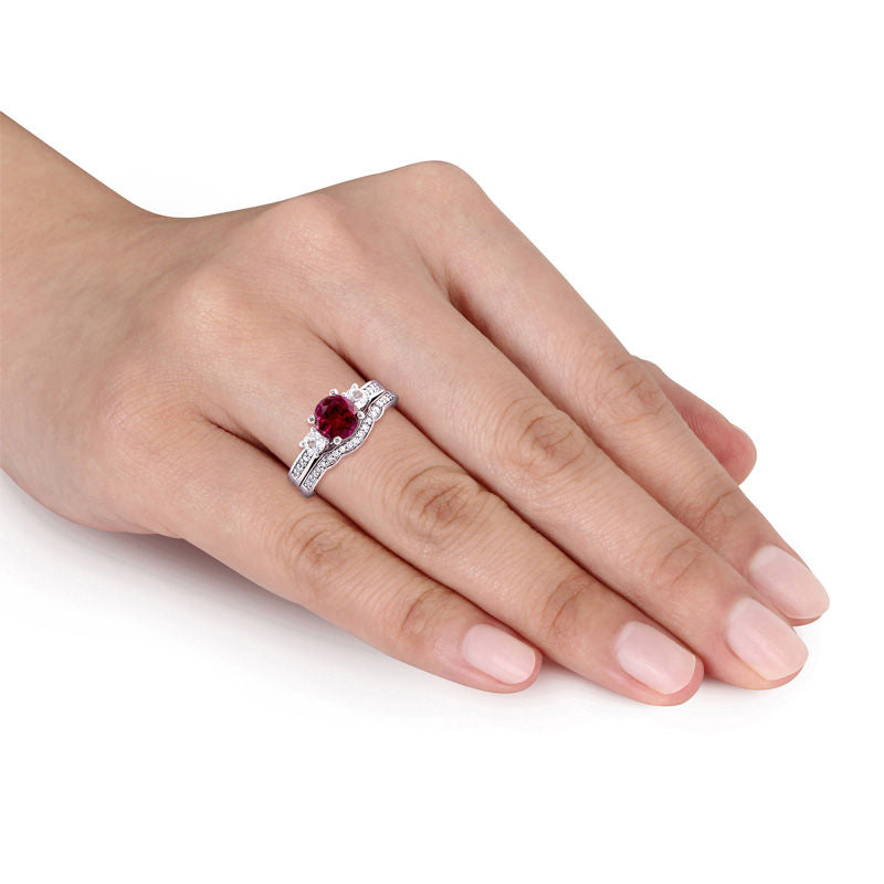 6.0mm Lab-Created Ruby and White Sapphire with 1/8 CT. T.W. Diamond Three Stone Bridal Set in 10K White Gold