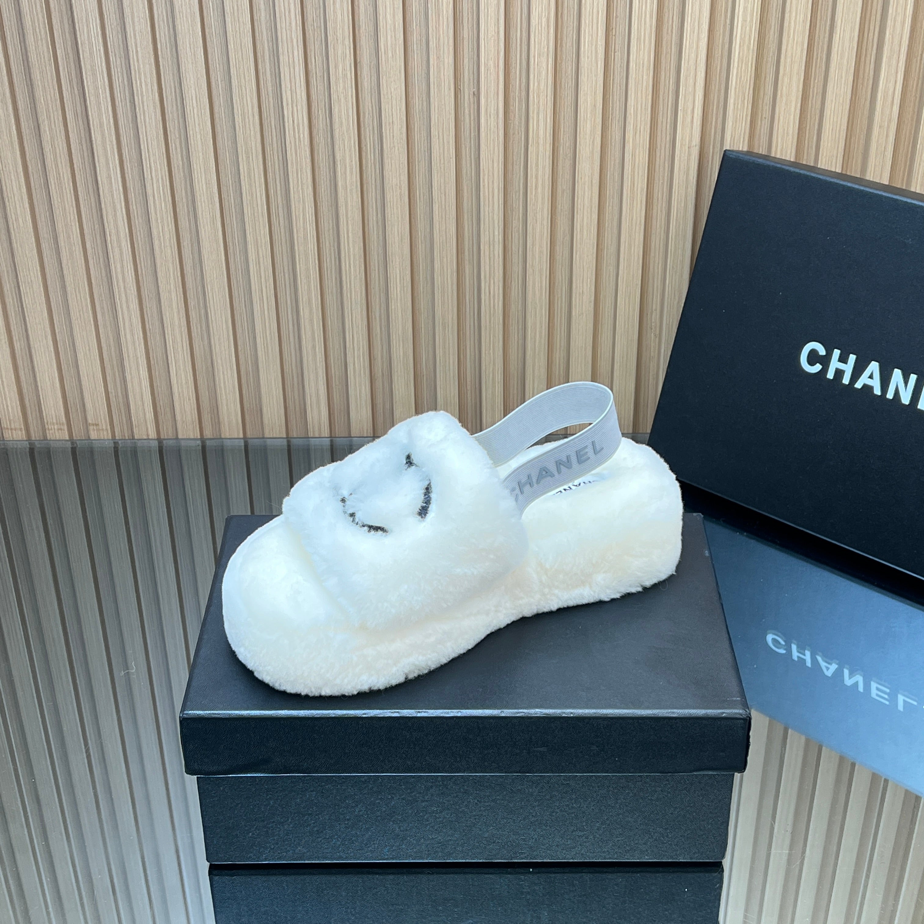 CHANEL 25S THICK-SOLED FURRY SLIPPERS WITH ELASTIC STRAPS IN WHITE FUR